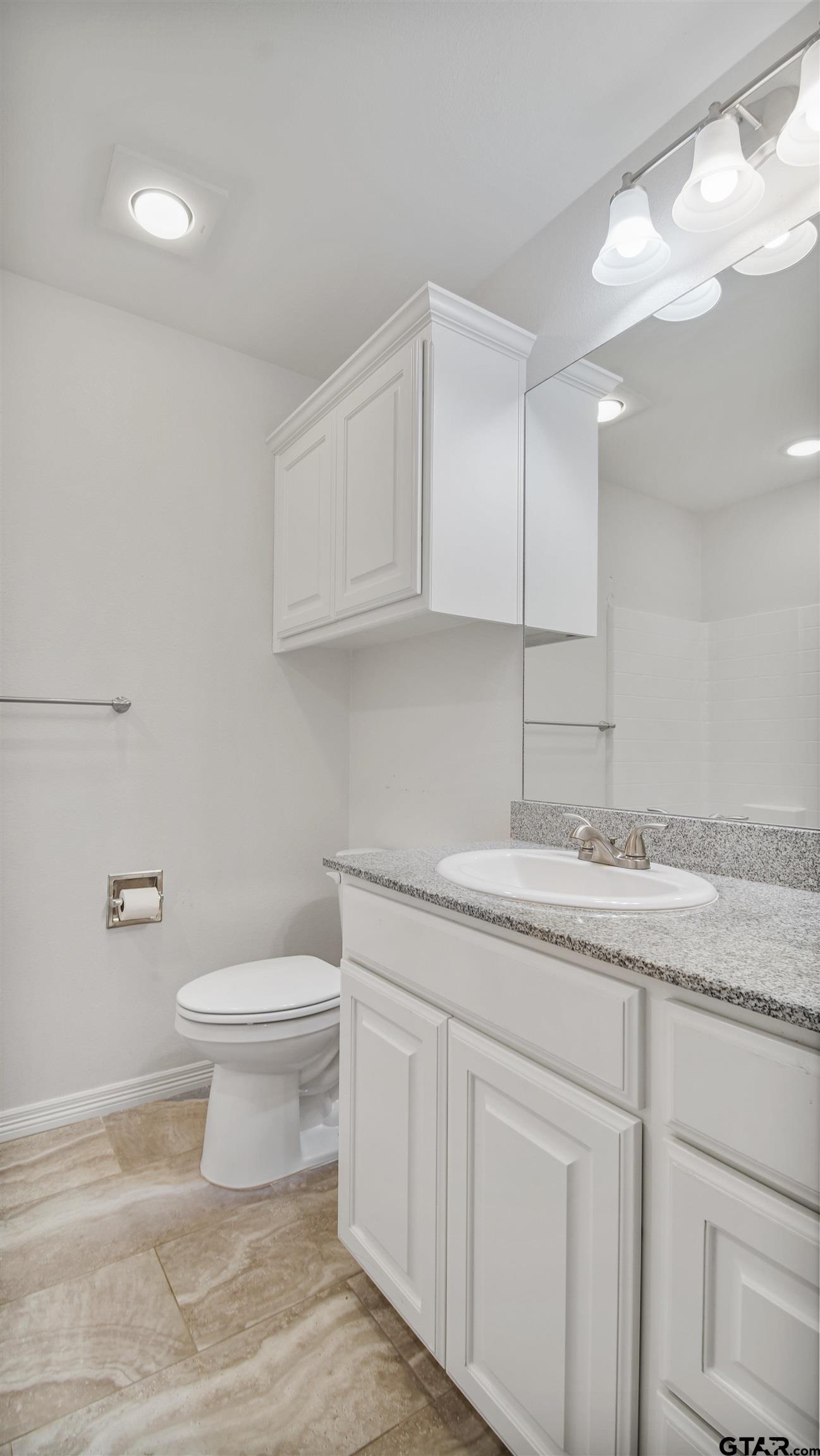 2220 Walton Road Tyler, TX 75701 - Photo 26 of 29 a bathroom with a granite countertop sink and a toilet