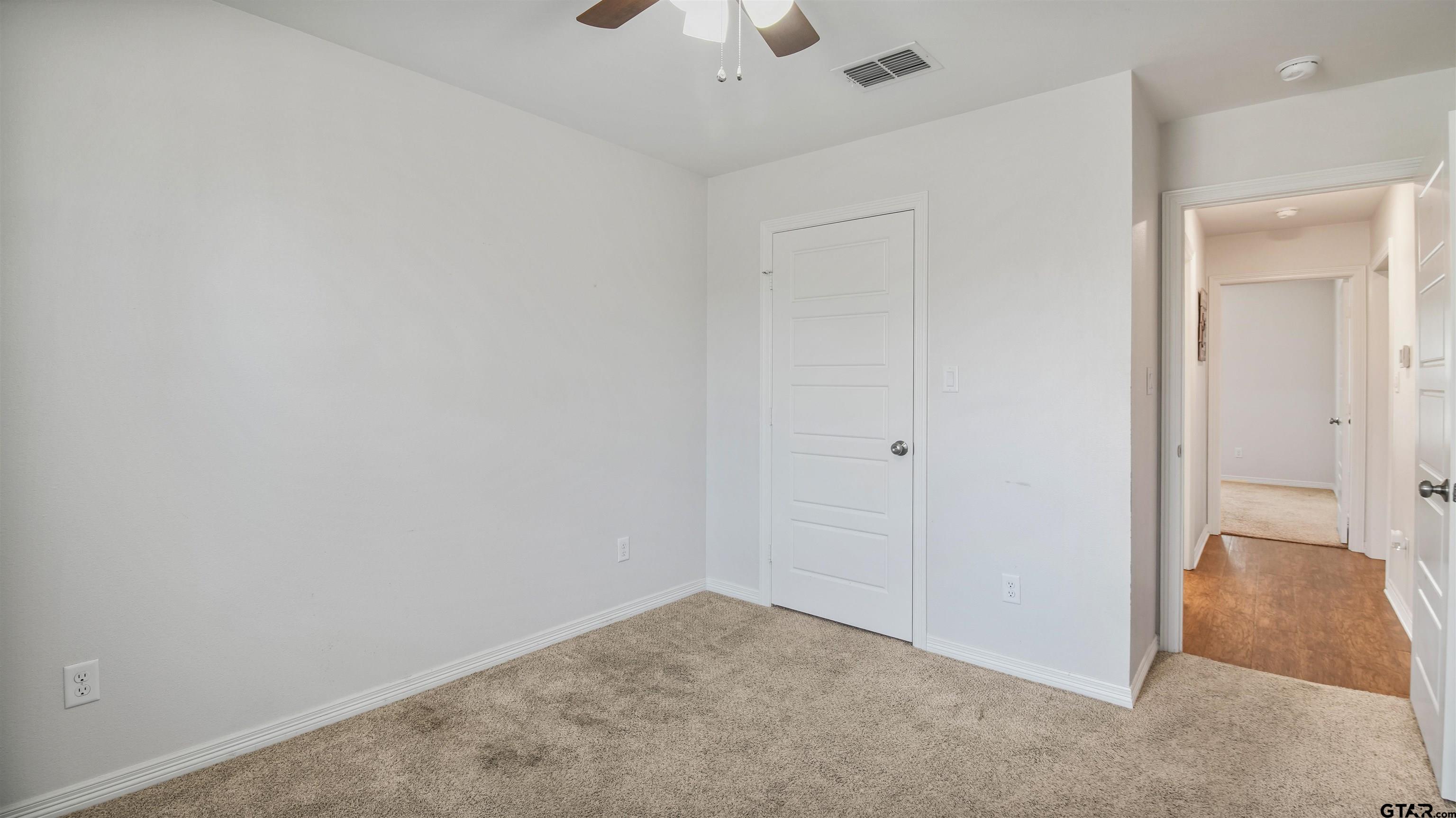 2220 Walton Road Tyler, TX 75701 - Photo 28 of 29 an empty room with a ceiling fan and a window