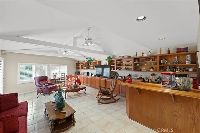 a living room with lots of furniture and a kitchen view