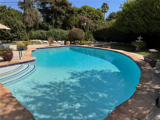 a view of a swimming pool with a yard