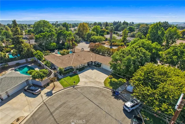 an aerial view of a house with a yard basket ball court and outdoor seating