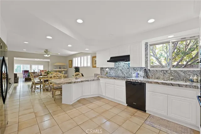 a kitchen with lots of counter top space and dining table