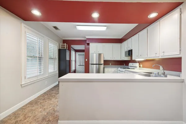 a view of kitchen with granite countertop cabinets