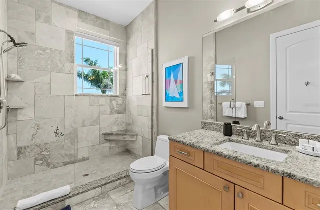 a bathroom with a granite countertop sink a shower and a mirror