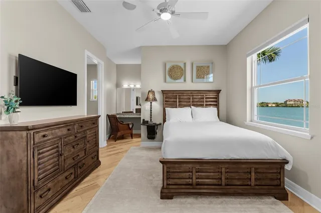 a living room with furniture a flat screen tv and kitchen view