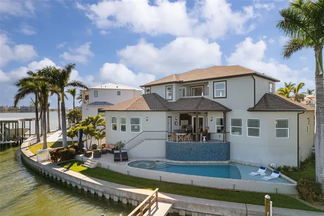 an aerial view of a city with lake view in back