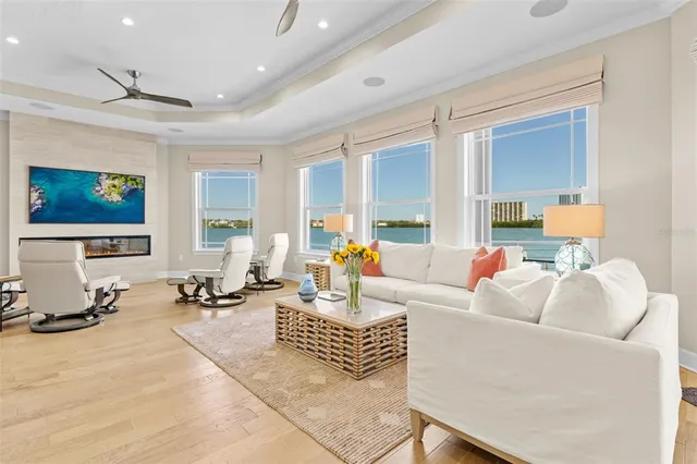 a living room with furniture a flat screen tv and a table