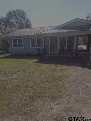 a view of house with yard