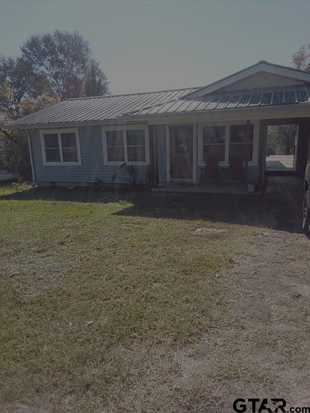 a view of house with yard