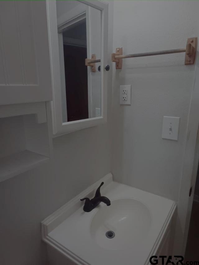 584 County Road 302 Carthage, TX 75633 - Photo 13 of 27 a bathroom with a sink and shower