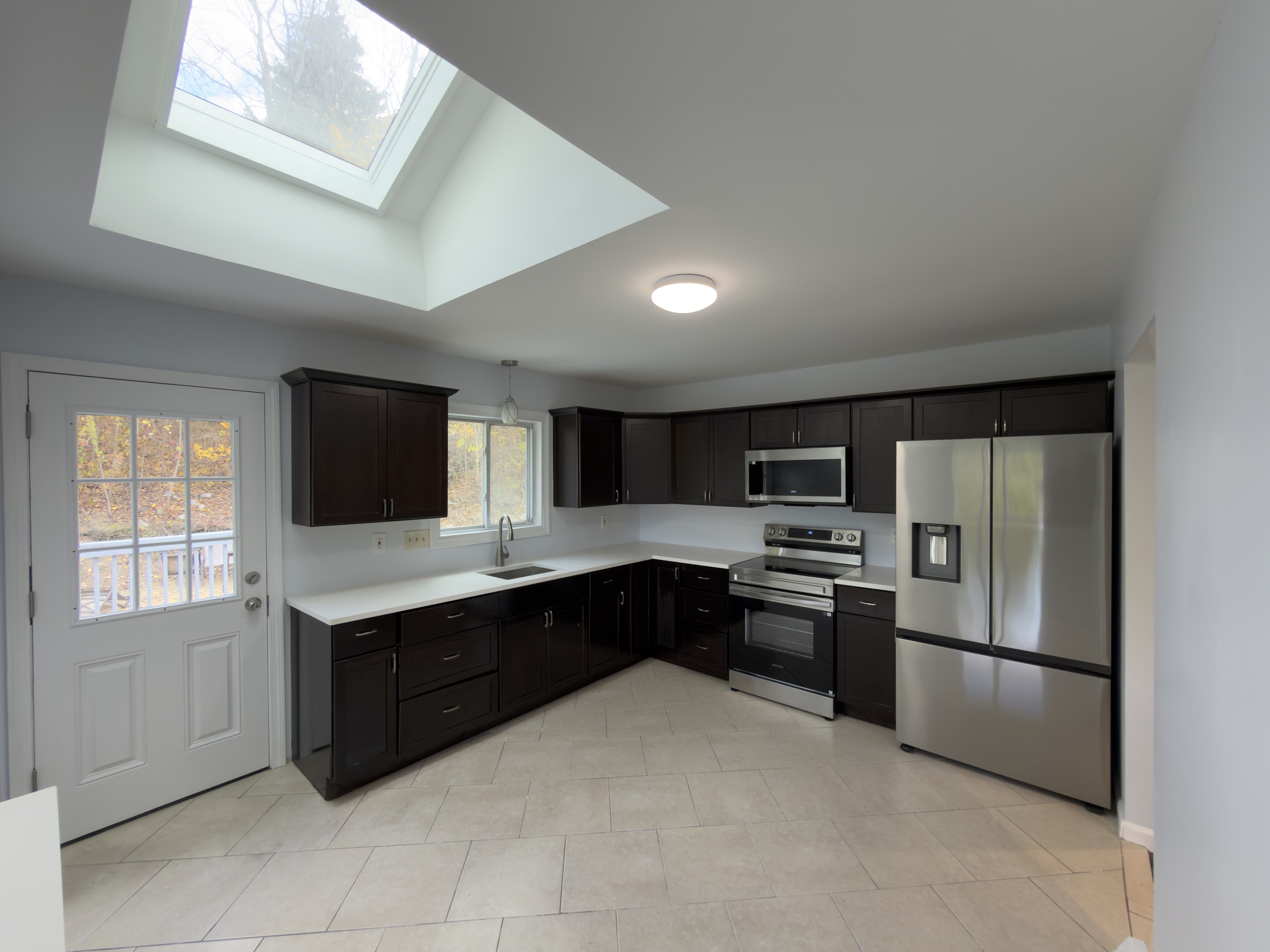 63 Haddad Road Waterbury, CT 06708 - Photo 17 of 30 a kitchen with stainless steel appliances granite countertop a refrigerator and a stove top oven