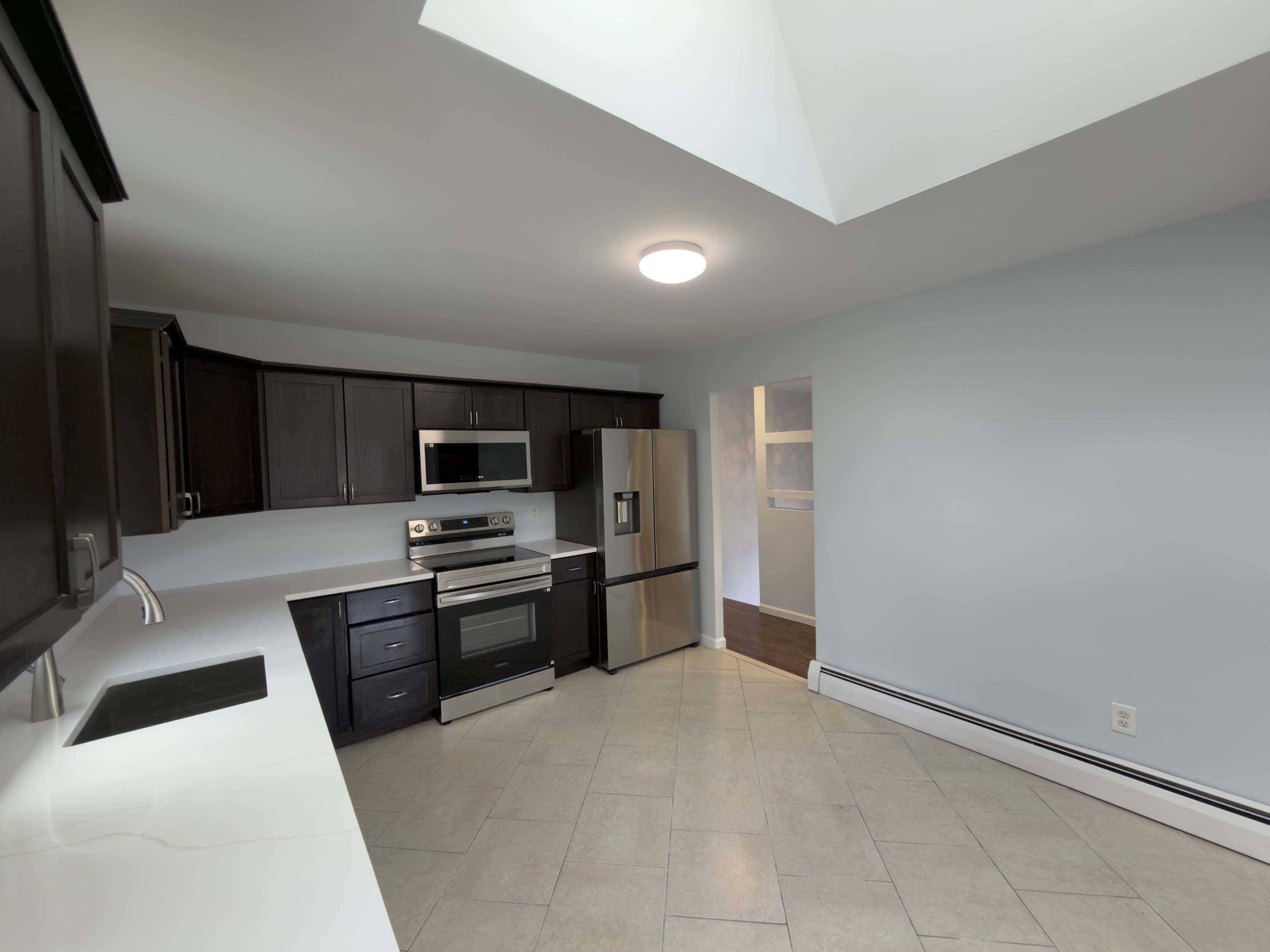 63 Haddad Road Waterbury, CT 06708 - Photo 18 of 30 a large kitchen with cabinets and stainless steel appliances