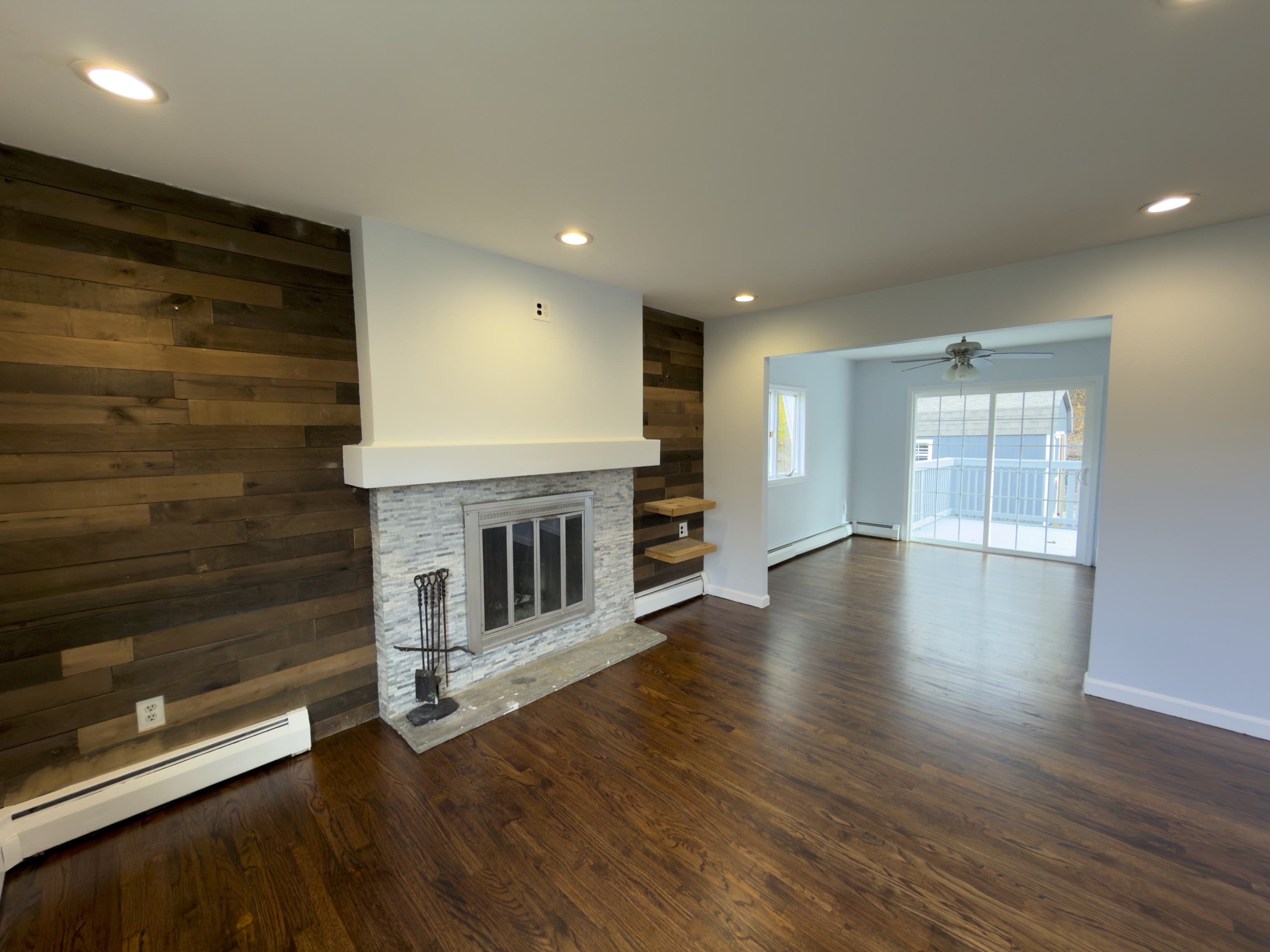 63 Haddad Road Waterbury, CT 06708 - Photo 21 of 30 an empty room with wooden floor fireplace and windows