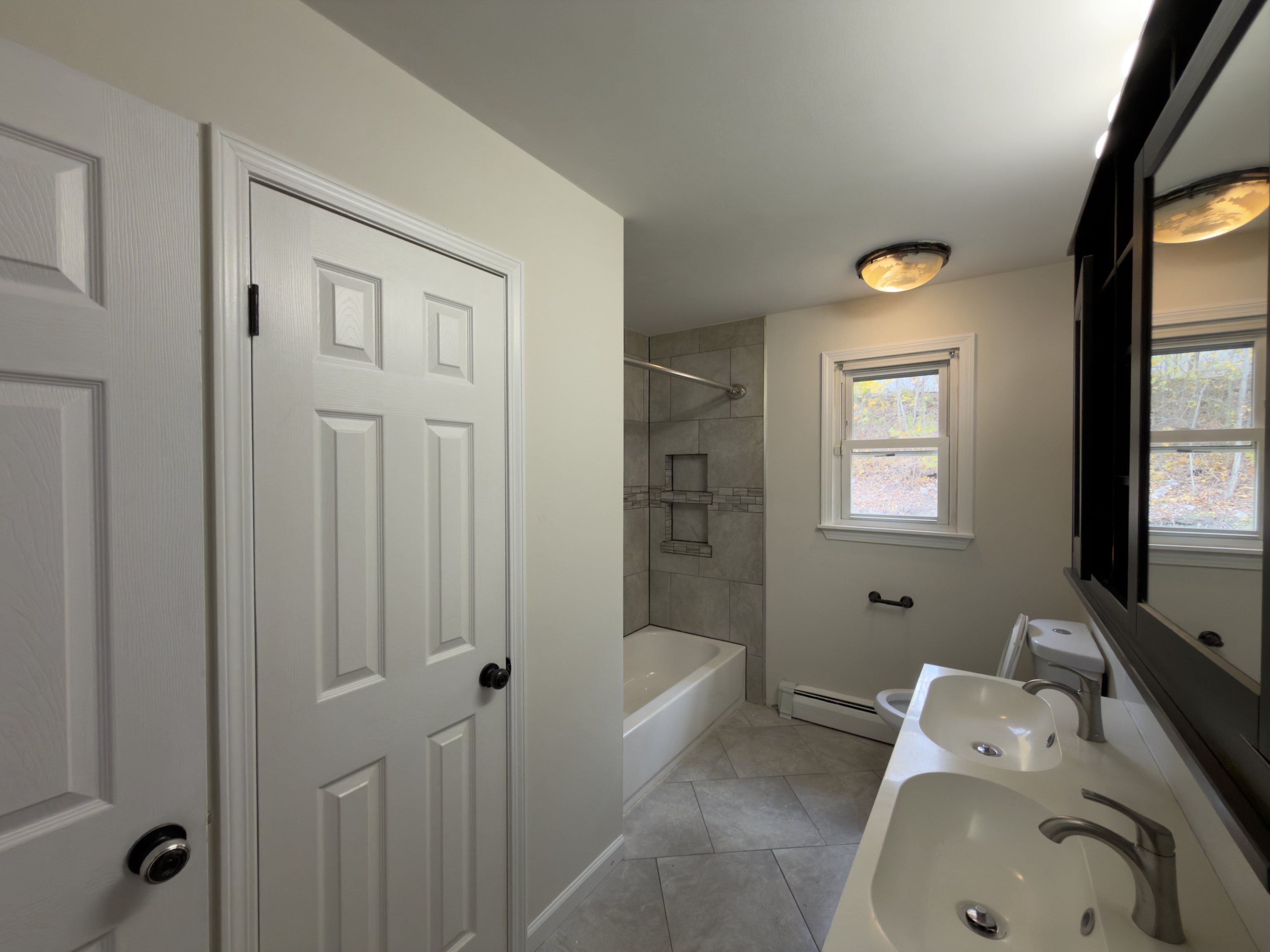 63 Haddad Road Waterbury, CT 06708 - Photo 24 of 30 a bathroom with a tub sink and mirror