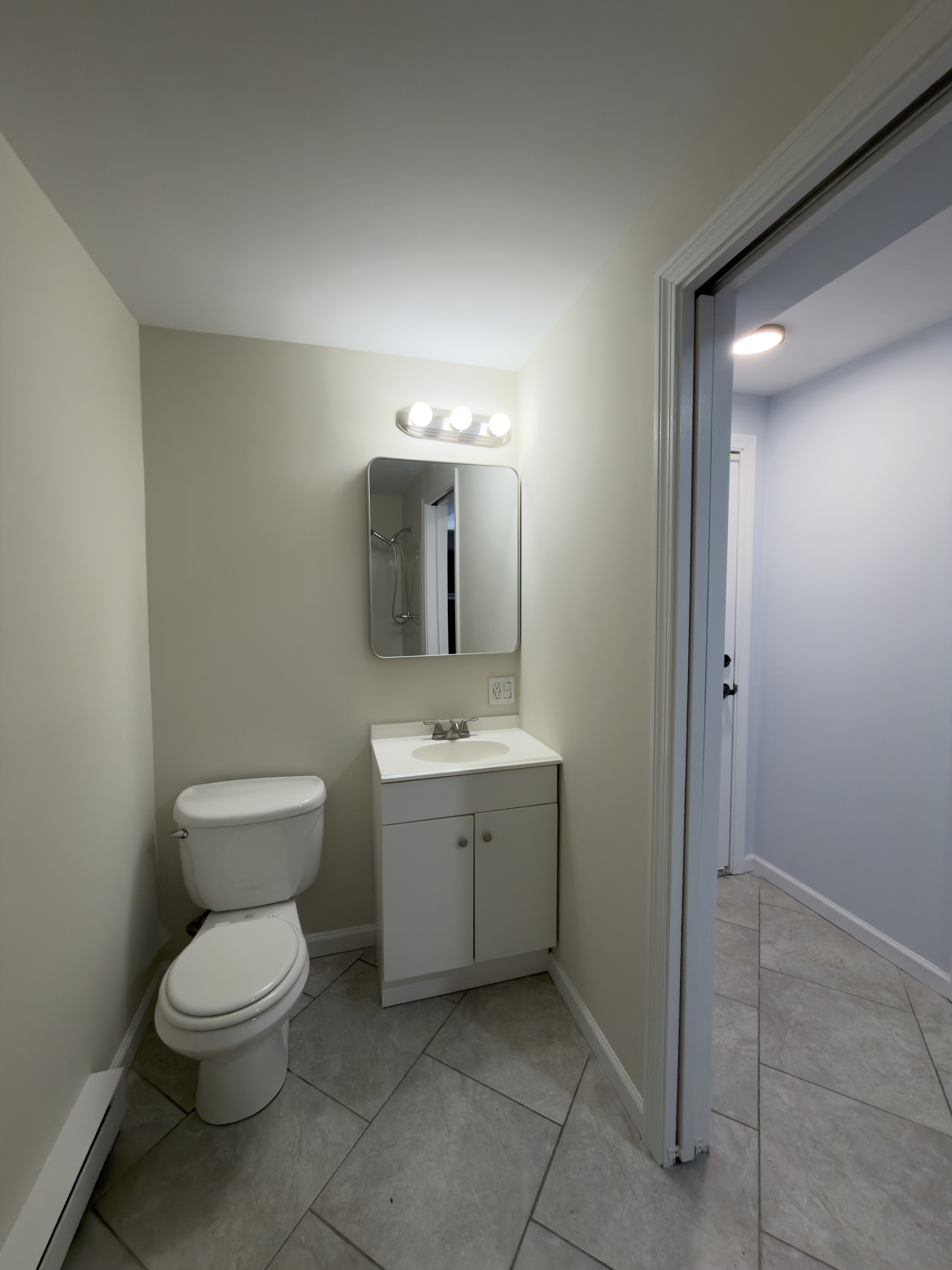63 Haddad Road Waterbury, CT 06708 - Photo 7 of 30 a bathroom with a toilet sink and mirror