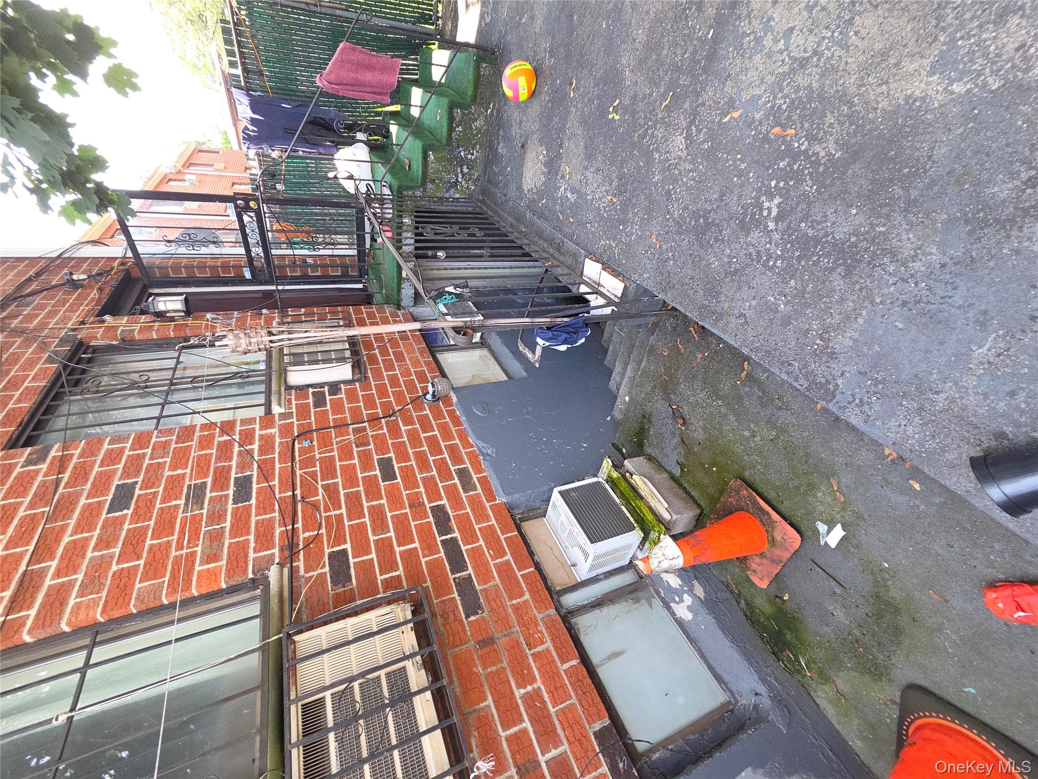 102-11 Strong Avenue Queens, NY 11368 - Photo 3 of 6 a view of a backyard with chairs and a fire pit