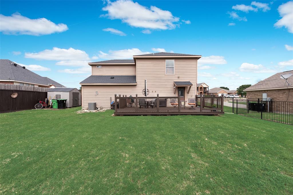 149 Cattlemans Creek Road Newark, TX 76071 - Photo 31 of 39 View of large backyard and oversized deck at 149 Cattlemans Creek Rd in the Chisholm Springs neighborhood in Newark, TX 76071
