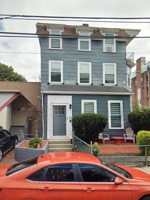 270-272 Sidney Street Cambridge, MA 02139 - Photo 15 of 24 a front view of house with yard and outdoor seating