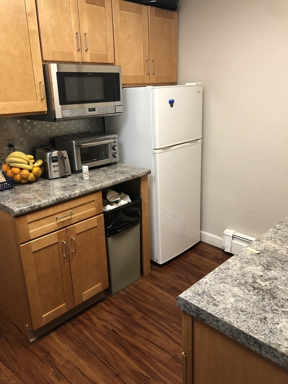 270-272 Sidney Street Cambridge, MA 02139 - Photo 6 of 24 a kitchen with a refrigerator and a stove top oven