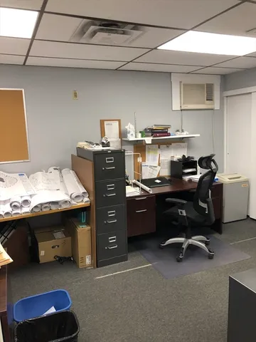 a room with a desk and a dresser