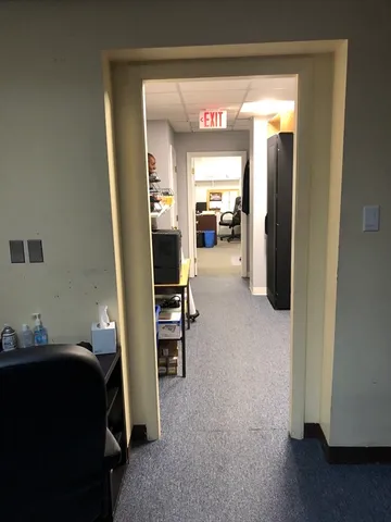 a room with a desk and a fireplace