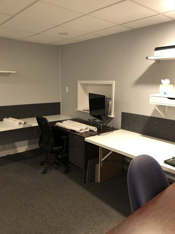 270-272 Sidney Street Cambridge, MA 02139 - Photo 9 of 24 a room with a desk and a fireplace