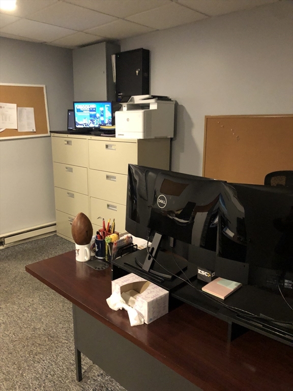 270-272 Sidney Street Cambridge, MA 02139 - Photo 10 of 24 a living room with furniture and a fireplace