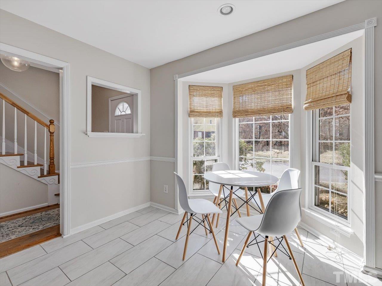 4612 Timberhurst Drive Raleigh, NC 27612 - Photo 4 of 35 a view of a dining room with furniture window and wooden floor