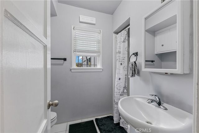 a bathroom with a sink a mirror and shower