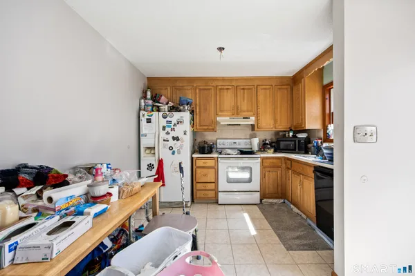 a kitchen with stainless steel appliances a stove a sink and a refrigerator