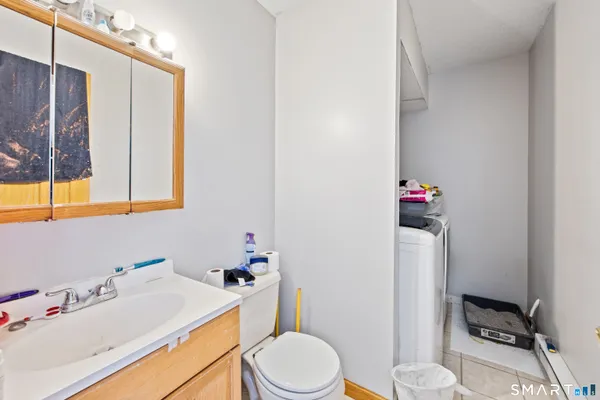 a bathroom with a sink toilet and mirror