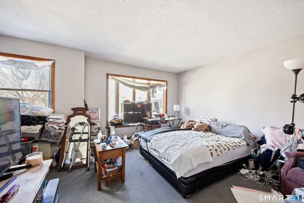 a bedroom with a bed a table and chair