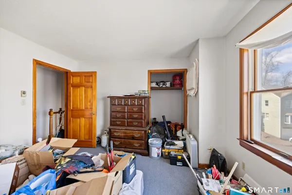 a bedroom with furniture and a window