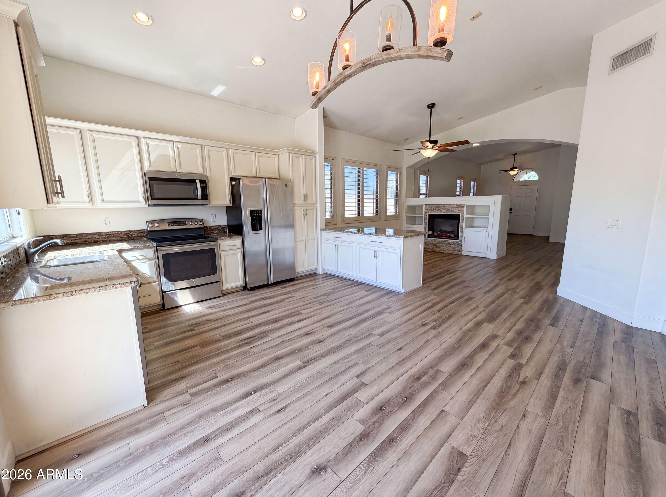 3951 East Timberline Road Gilbert, AZ 85297 - Photo 7 of 28 a kitchen with stove top oven and refrigerator