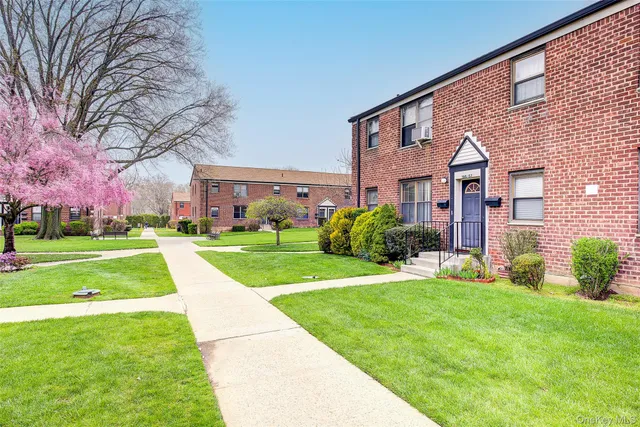 a view of a big building with a big yard and large trees