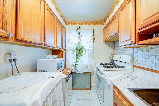 a kitchen with a stove a sink and a microwave