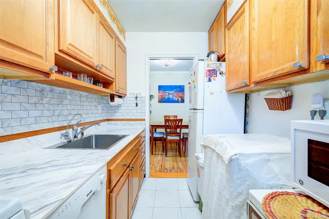 a kitchen with stainless steel appliances granite countertop a sink and dishwasher a stove top oven with wooden floor
