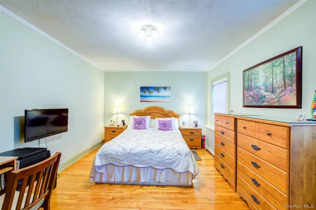 a bedroom with furniture and flat screen tv