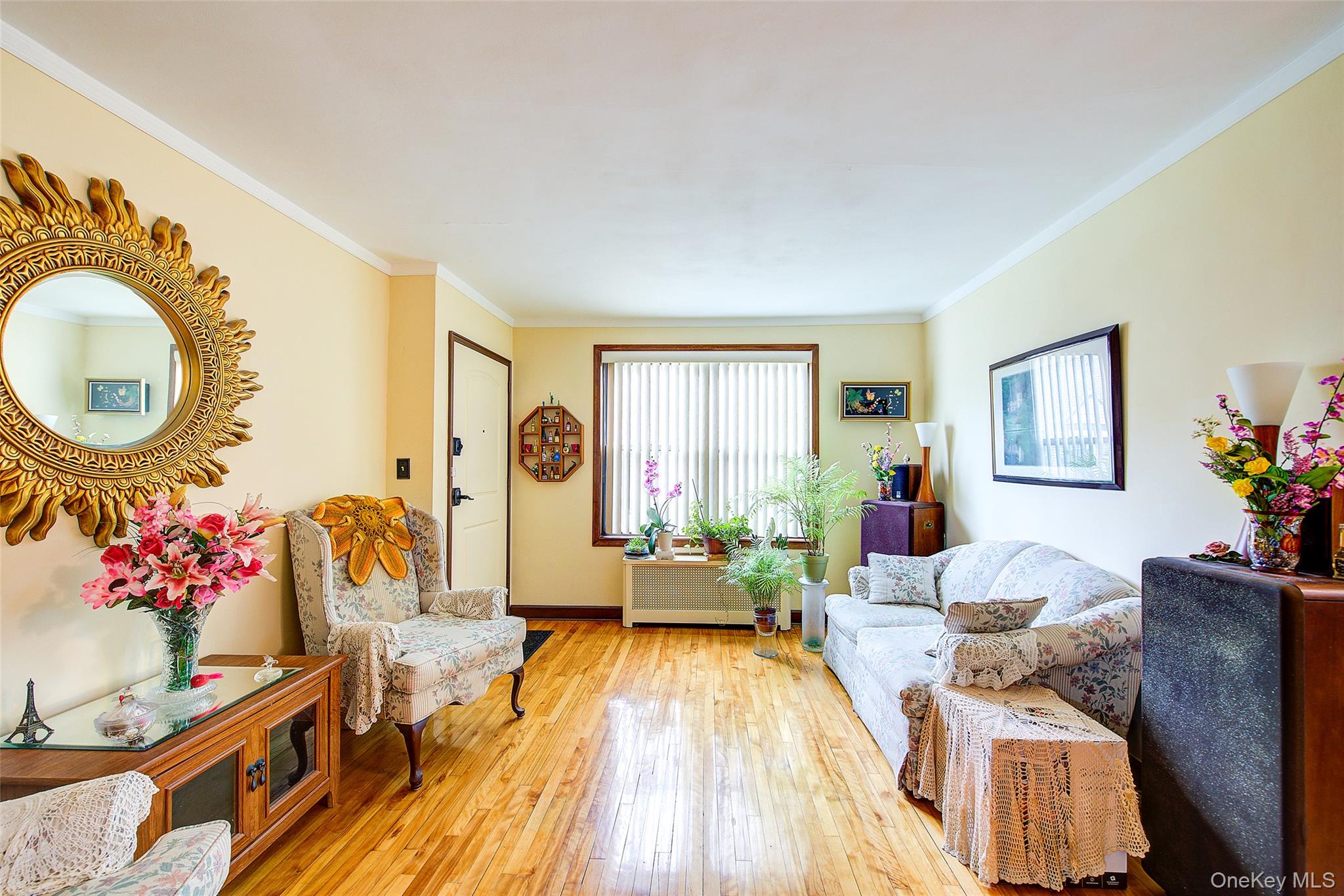 196-57 69th Avenue, Unit 1 Queens, NY 11365 - Photo 6 of 18 a living room with furniture and a chandelier