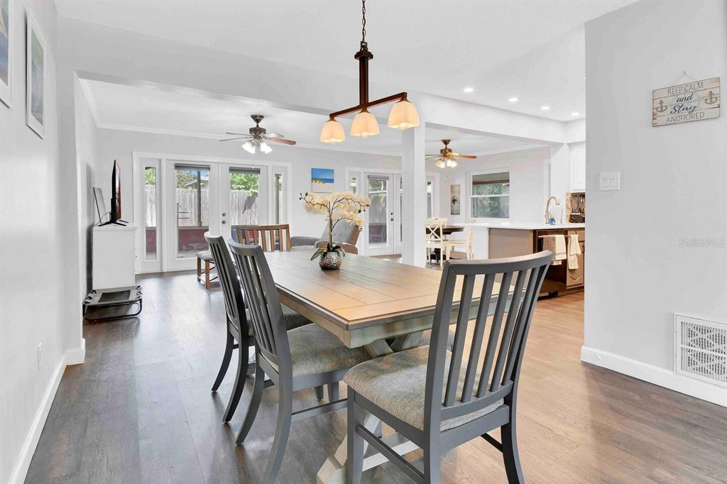 863 Bay Breeze Terrace Largo, FL 33770 - Photo 11 of 19 a view of a dining room with furniture and wooden floor