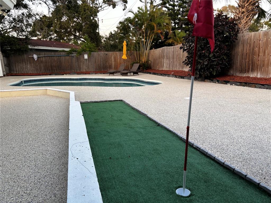 863 Bay Breeze Terrace Largo, FL 33770 - Photo 19 of 19 a backyard of a house with lots of green space