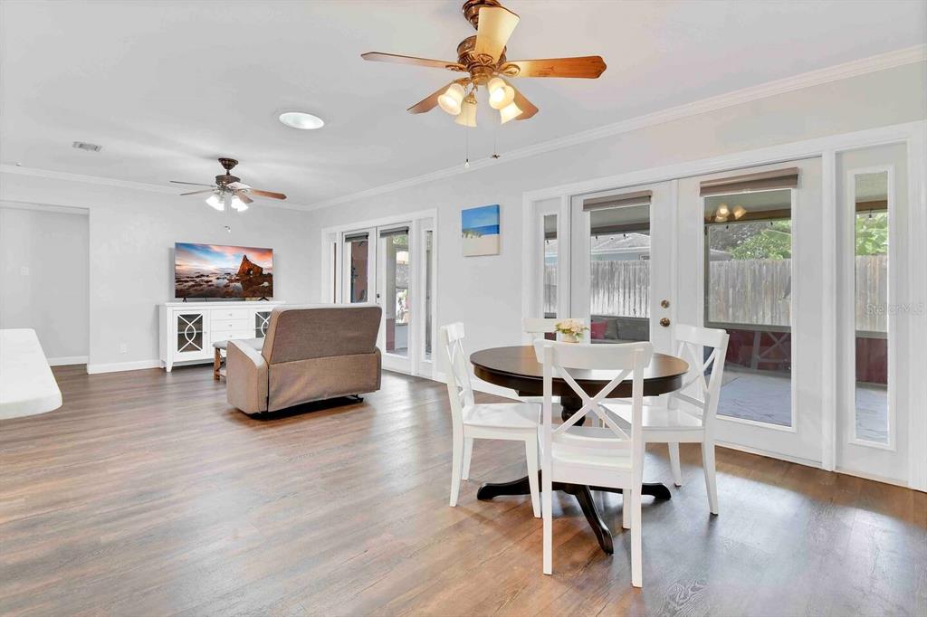 863 Bay Breeze Terrace Largo, FL 33770 - Photo 10 of 19 a dining room with furniture a chandelier and wooden floor