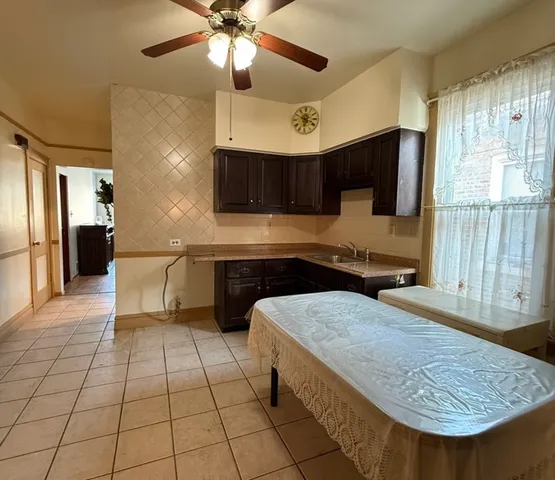 a kitchen with stainless steel appliances granite countertop a sink and a refrigerator