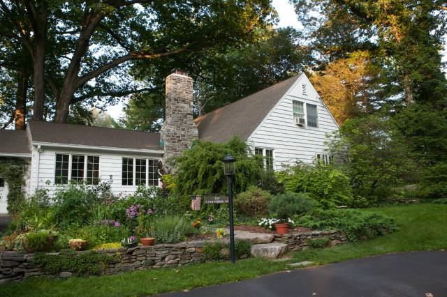 a view of a house with a yard and tree s