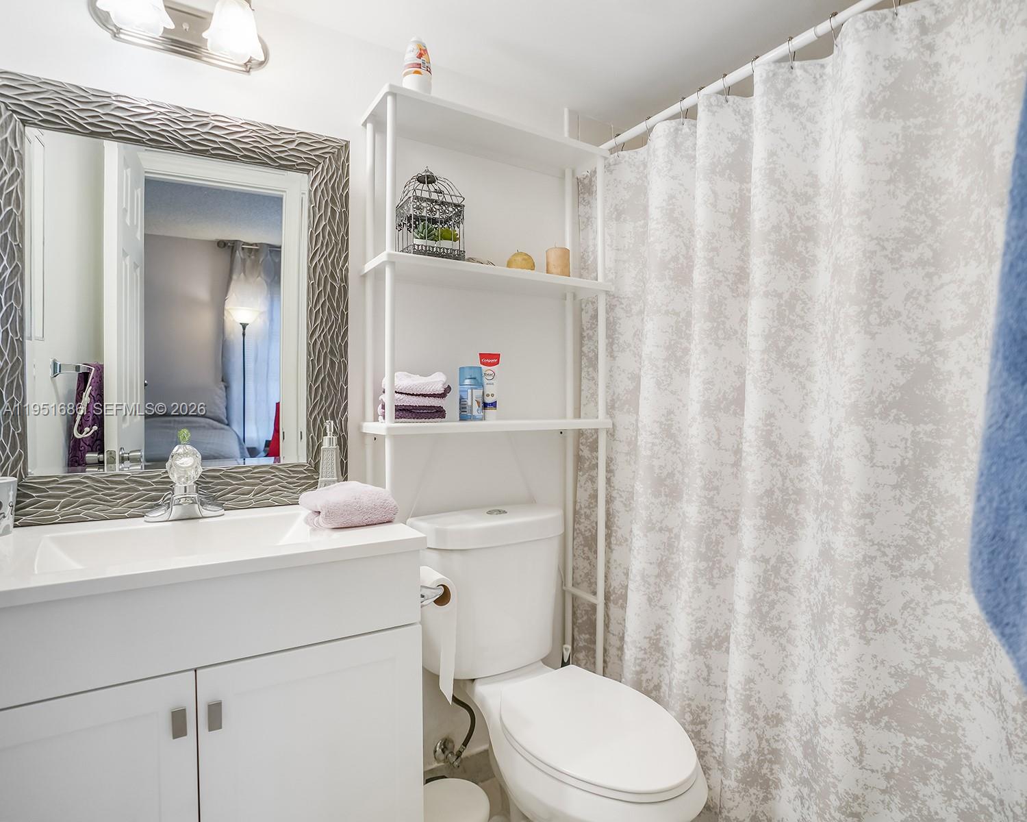 3531 Inverrary Drive, Unit 107 Lauderhill, FL 33319 - Photo 12 of 34 a bathroom with a sink a toilet and a mirror