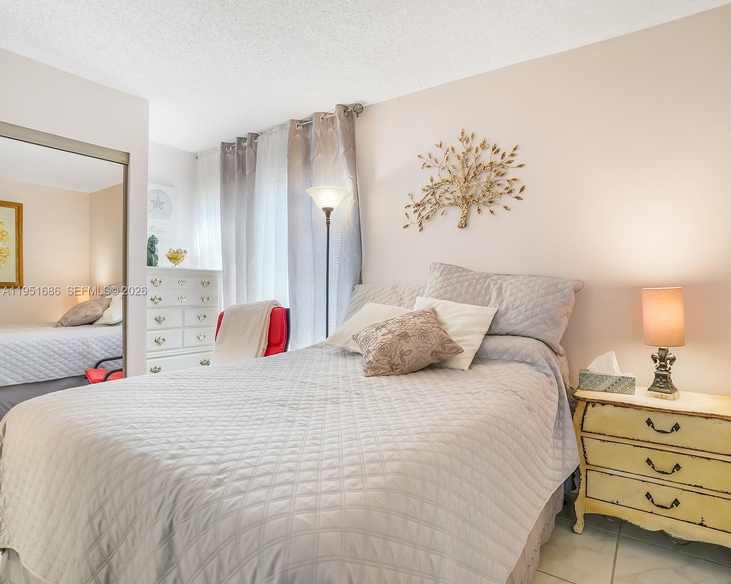 3531 Inverrary Drive, Unit 107 Lauderhill, FL 33319 - Photo 13 of 34 a bedroom with a bed and a painting on the wall