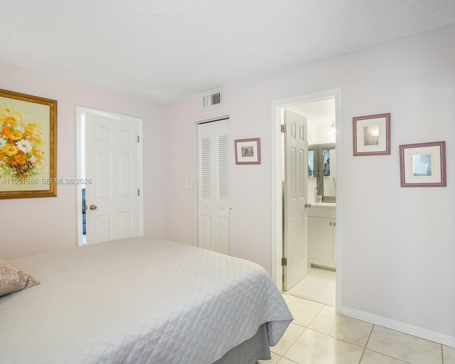 3531 Inverrary Drive, Unit 107 Lauderhill, FL 33319 - Photo 14 of 34 a bedroom with a bed and a painting on the wall