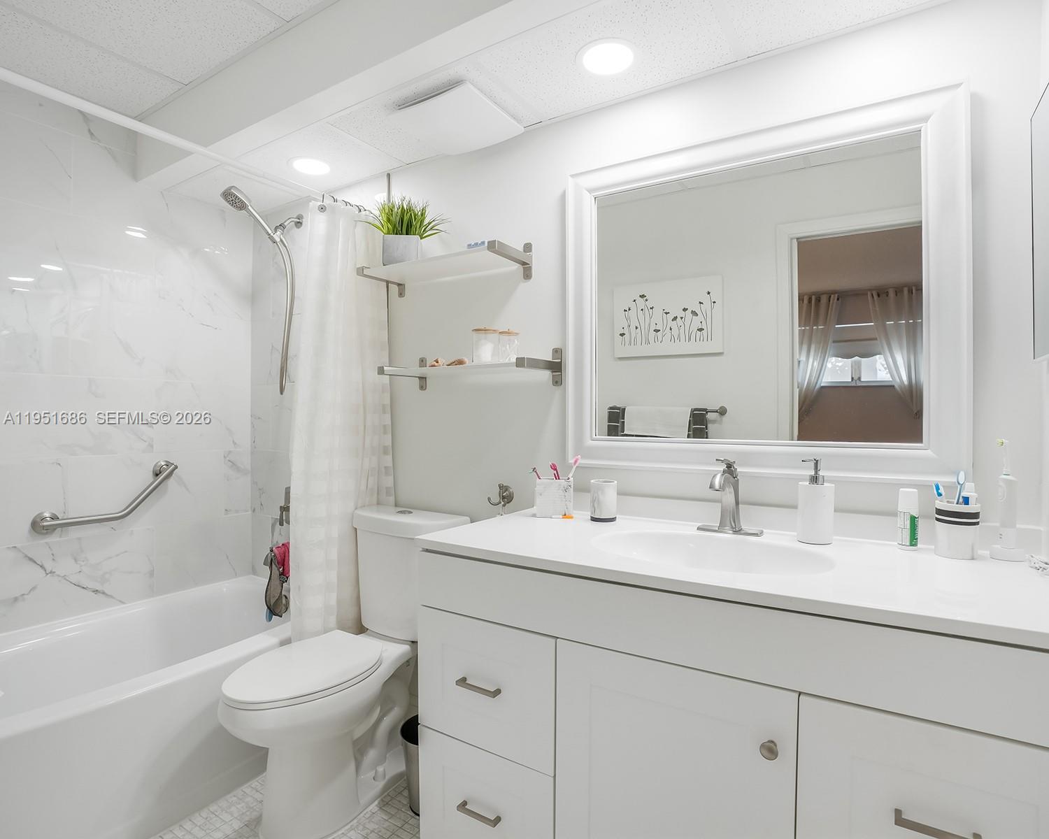 3531 Inverrary Drive, Unit 107 Lauderhill, FL 33319 - Photo 16 of 34 a bathroom with a double vanity sink toilet and shower