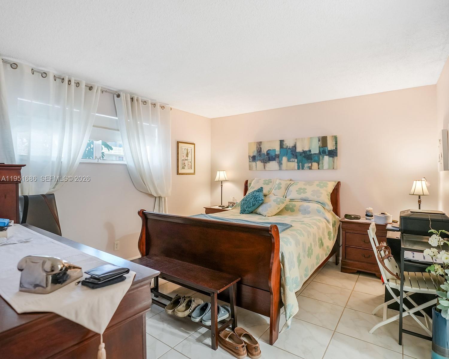 3531 Inverrary Drive, Unit 107 Lauderhill, FL 33319 - Photo 17 of 34 a spacious bedroom with a bed and a desk