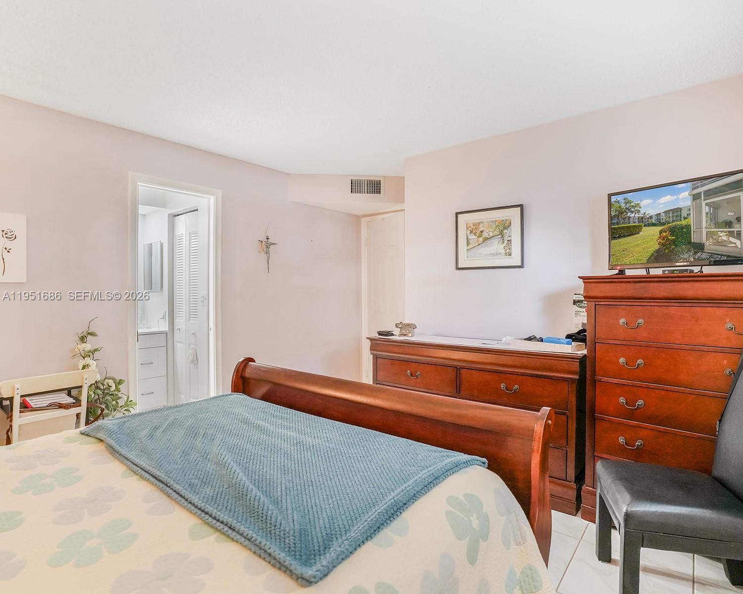 3531 Inverrary Drive, Unit 107 Lauderhill, FL 33319 - Photo 18 of 34 a bedroom with a bed and dresser